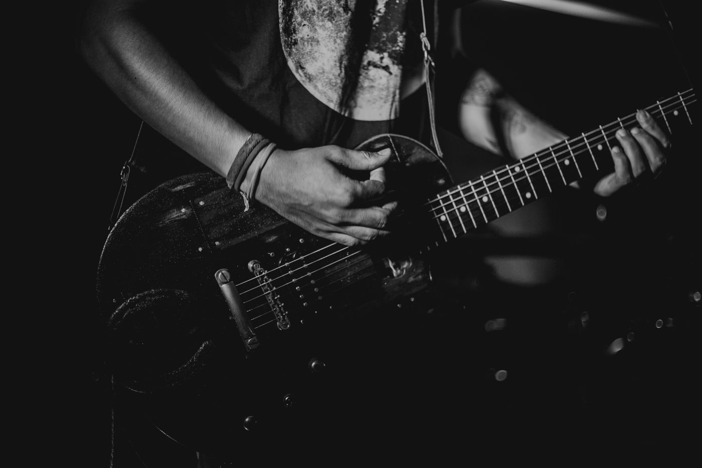 Musician playing a dark custom electric guitar