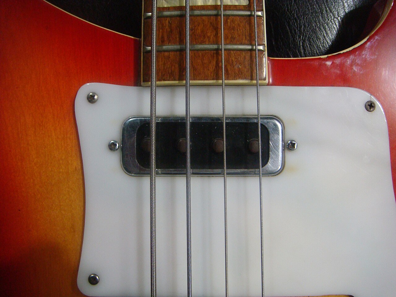 Electric bass guitar neck joint and pickup area